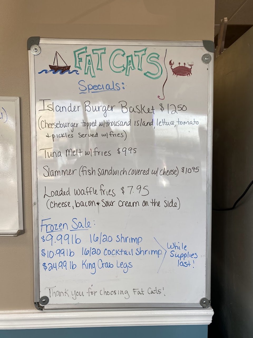 Menu board listing seafood dinners and baskets.